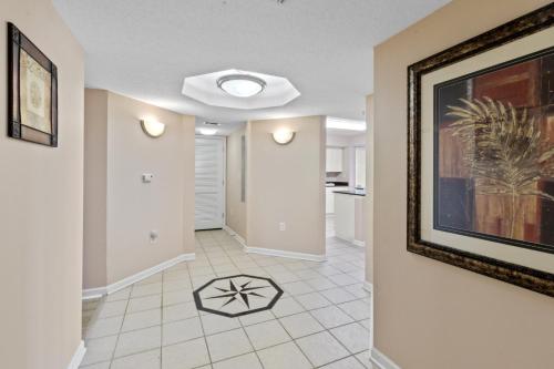 a living room with a painting on the wall at Yacht Club Villas #1-701 condo in Myrtle Beach