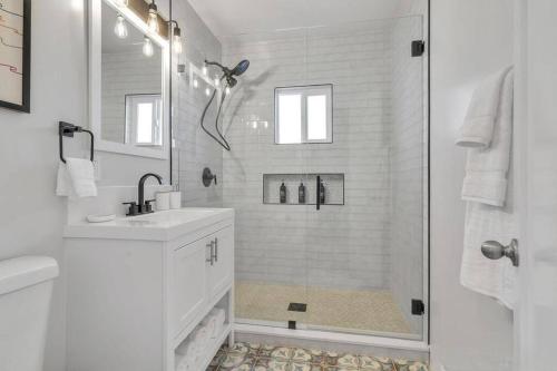 a white bathroom with a shower and a sink at San Diego Heights - Urban Legend in San Diego
