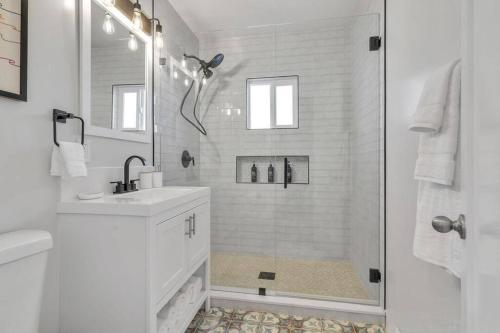 a white bathroom with a shower and a sink at San Diego Heights - Urban Legend in San Diego