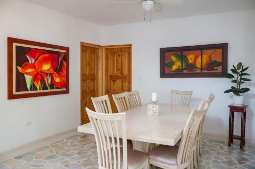 une salle à manger avec une table et des chaises blanches dans l'établissement Casa Isidra, à Rivera