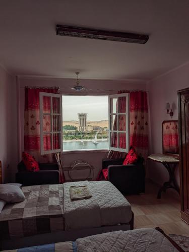 a bedroom with a bed and a window with a view at TOP HOTEL in Aswan
