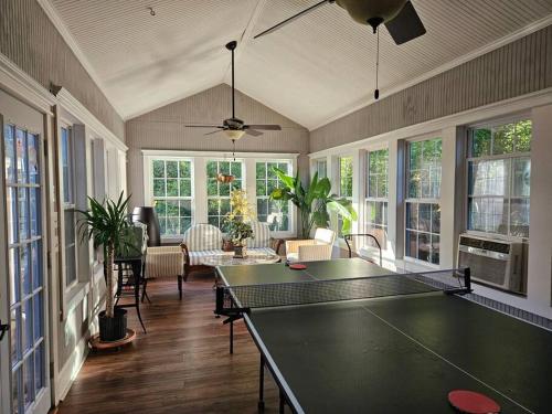 a living room with a ping pong table in it at Close to Downtown, 11-Person Swim Spa-Hot Tub, 75" TV 4 Movie Nights, Spacious, Walk To Restaurants, Ping Pong in Atlanta