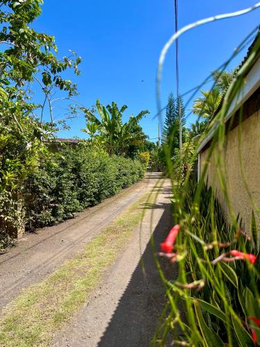 a dirt road with a fence next to a dirt road at Tiaki Guesthouse - Cozy Modern Studio - 5min drive from the beach and Punaauia center in Punaauia
