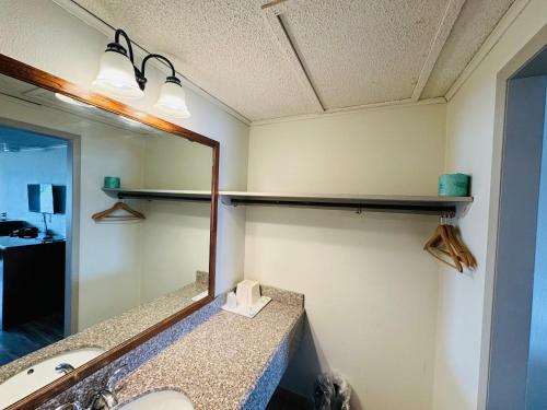 a bathroom with a mirror and a sink at Knights Inn Bridgeport Frankenmuth in Bridgeport