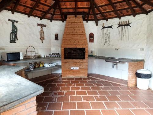 - une cuisine équipée d'un four en briques dans l'établissement Casa dos Pinheiros Campos do Jordão, à Campos do Jordão