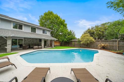 a swimming pool in the backyard of a home at Houston Pool Retreat WiFi Yard BBQ Games TVs in Houston