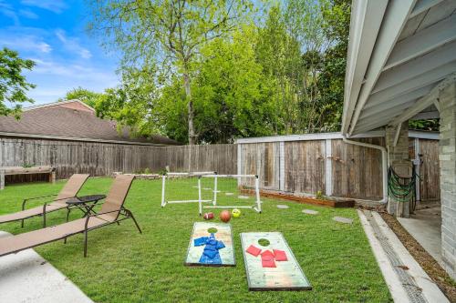 a backyard with a ping pong game on the grass at Houston Pool Retreat WiFi Yard BBQ Games TVs in Houston