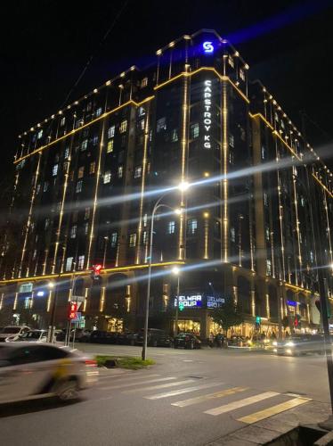 a large building with lights on top of it at night at Резиденс in Bishkek