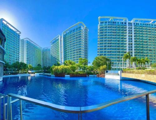 a large swimming pool in front of tall buildings at SM Bicutan Condominium in Manila