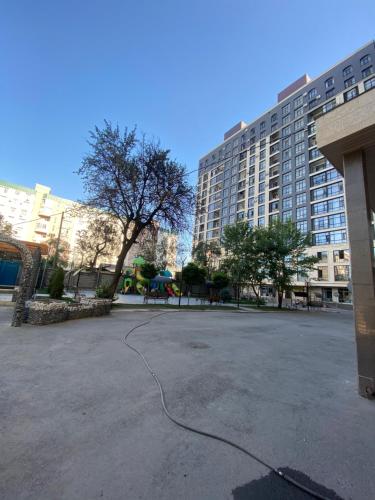 a parking lot in front of a large building at Резиденс in Bishkek