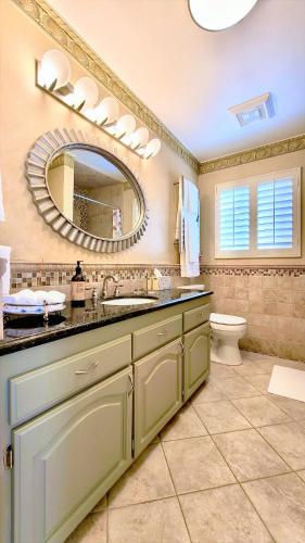 a bathroom with a sink and a mirror and a toilet at CASA LUX MONICA Prime Santa Monica Luxury Home ONE-OF-A-KIND in Los Angeles