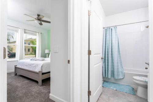 een slaapkamer met een bed, een toilet en een raam bij Home away from Home with Private Pool CHG103 in Kissimmee