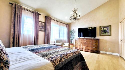 a bedroom with a large bed and a flat screen tv at CASA LUX MONICA Prime Santa Monica Luxury Home ONE-OF-A-KIND in Los Angeles