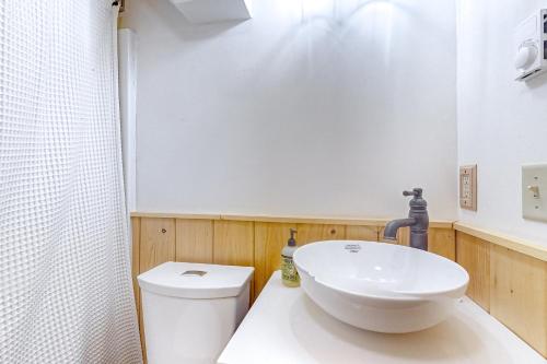 a bathroom with a white sink and a toilet at Little Bend Haven in Wilmington