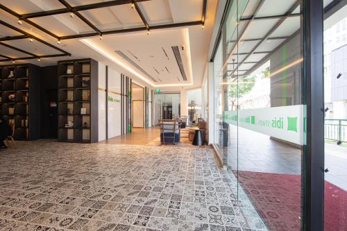 a lobby of a building with a glass wall at ibis Styles Singapore Albert in Singapore