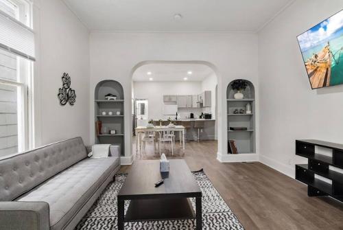 a living room with a couch and a table at Modern Apt - Downtown Charm - Ideal Location in Indianapolis