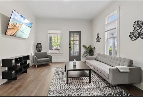 a living room with a couch and a chair at Modern Apt - Downtown Charm - Ideal Location in Indianapolis