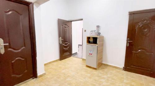 a hallway with two doors and a small refrigerator at CEO HOMES AND APARTMENT in Warri
