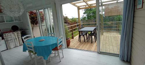 a room with a blue table and chairs on a balcony at Ti Bamboo in Le Tampon