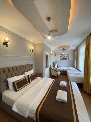 a hotel room with a large bed and a couch at Berce Hotel Istanbul in Istanbul