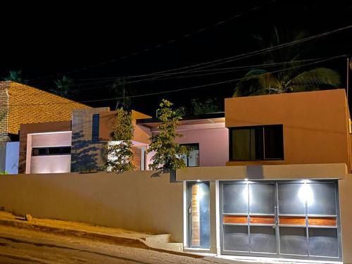 a building with a lit up window at night at Casa Kamila en el centro de Todos Santos in Todos Santos