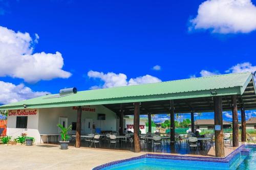 a restaurant with a pool in front of a building at Bula Villas in Nadi