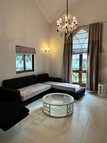 a living room with a couch and a coffee table at Riviera Hermitage in Anjuna