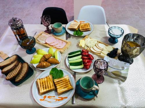 a table with plates of food on a table at The Friends in Yerevan