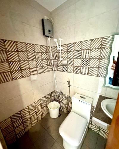 a bathroom with a toilet and a sink at The farmhouse villa beach resort in Morong