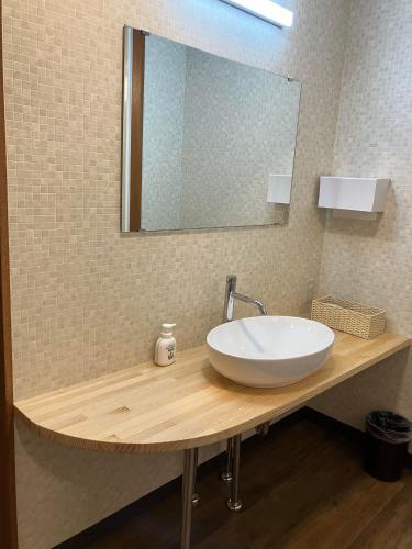 a bathroom with a sink and a mirror at Yodoya in Toyooka