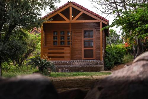 a small wooden cabin in the middle of a forest at Leo wooden resorts in Hampi