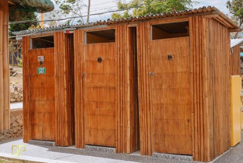 a set of four wooden doors sitting next to each other at PAPABO Adventure Village in Moalboal