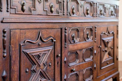 a wooden cabinet with intricate designs on it at Charming On Charles in Launceston