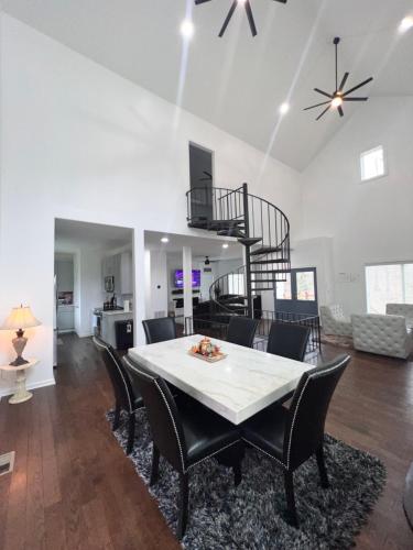 a dining room and living room with a table and chairs at The Getaway House ATL in Carrollton