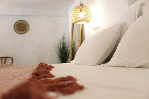 a bedroom with a bed with white pillows and a lamp at Katoi traditional house in Éxo Khóra