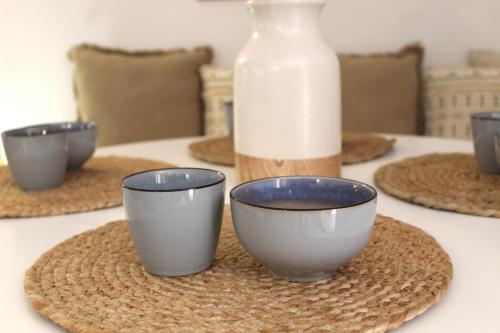 a table with bowls and a bottle of milk at Katoi traditional house in Éxo Khóra