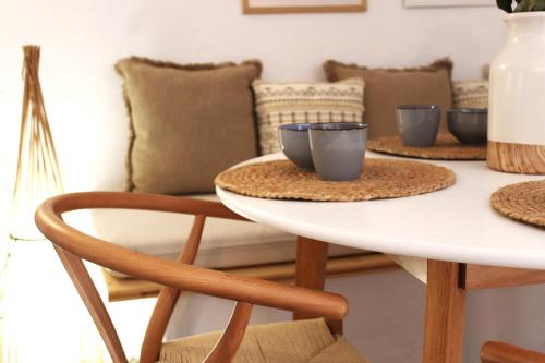 a table with three cups on it with a couch at Katoi traditional house in Éxo Khóra