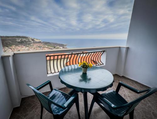 a table and chairs on a balcony with a view of the ocean at Kakavanen’s Sea View apartment in Balchik