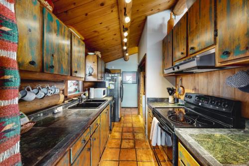 a kitchen with wooden cabinets and a stove at Bucks House in Jackson