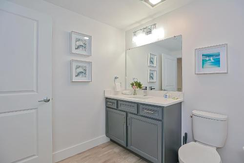 a bathroom with a sink and a toilet and a mirror at Harbourtown Suites, Unit 213 in Plymouth