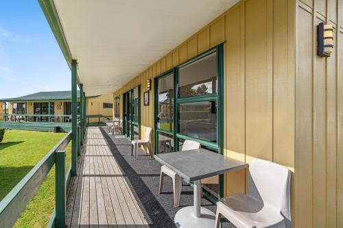 a building with a table and chairs on a balcony at Tasman Holiday Parks - Miranda in Miranda