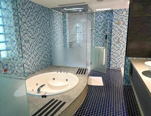 a bathroom with a tub and a shower and a sink at All-Ur Boutique Motel-Jhu Shan Branch in Zhushan