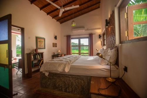 a bedroom with a bed in a room with a window at Kumbura Homestay in Sigiriya