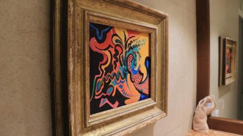 a painting in a frame on a wall at Dunest Villa in Bentota