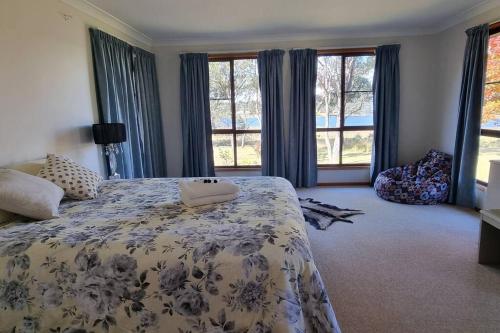 a bedroom with a large bed with a blanket at Burramere Homestead in Eukey