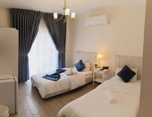 Postel nebo postele na pokoji v ubytování The Boutique Hotel Amman
