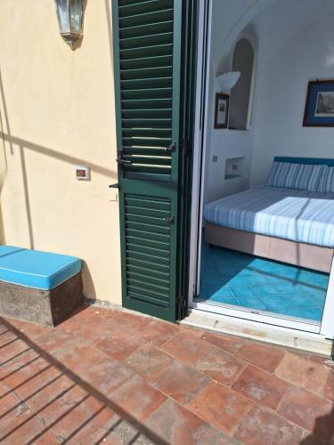 a bedroom with a bed and a open door at L'Osservatorio - Luxury Guest House in Capri