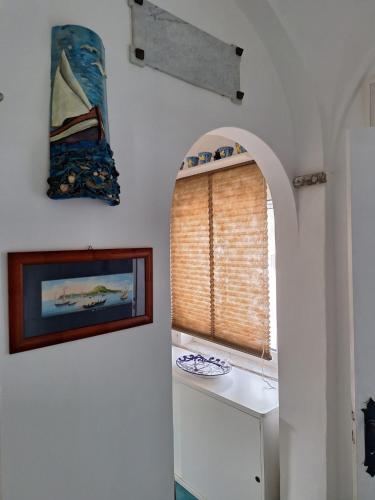 a hallway with a window and a picture of a boat at L'Osservatorio - Luxury Guest House in Capri