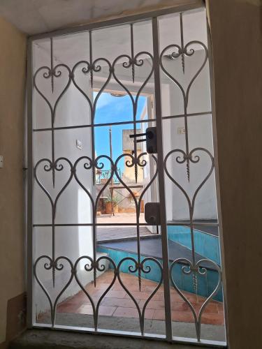 a door with a view of a pool through a gate at L'Osservatorio - Luxury Guest House in Capri