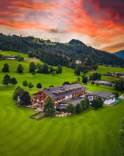 an aerial view of a house in a green field at Rasmushof - Hotel Kitzbühel in Kitzbühel